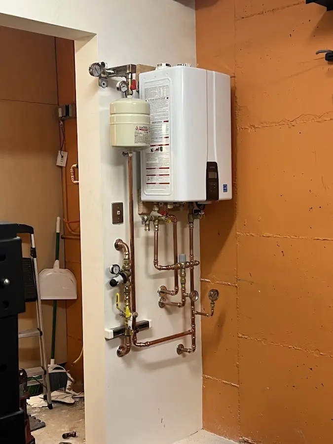 Plumbing technician inspecting water heater connections in Corpus Christi